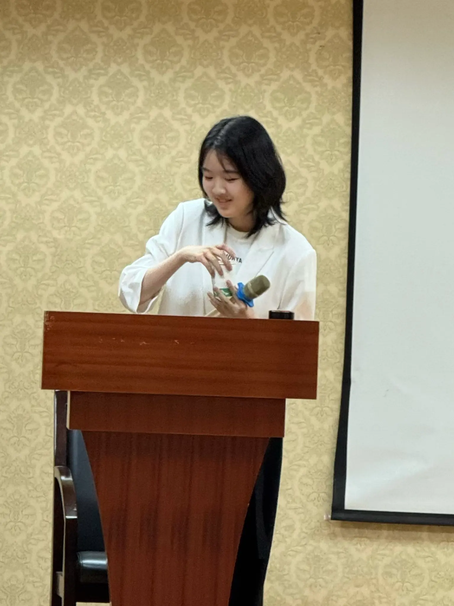 Quinn Zhang speaking at a podium